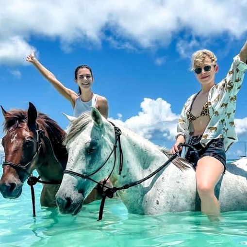 Horse riding along Zanzibar beach at sunset